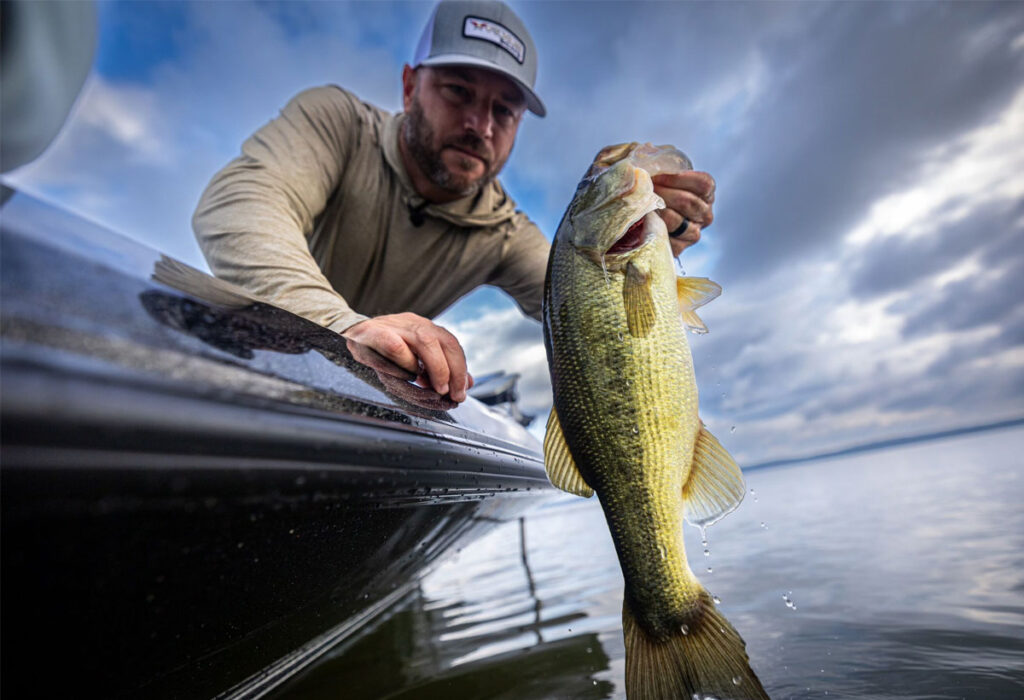 Man lifts fish from water